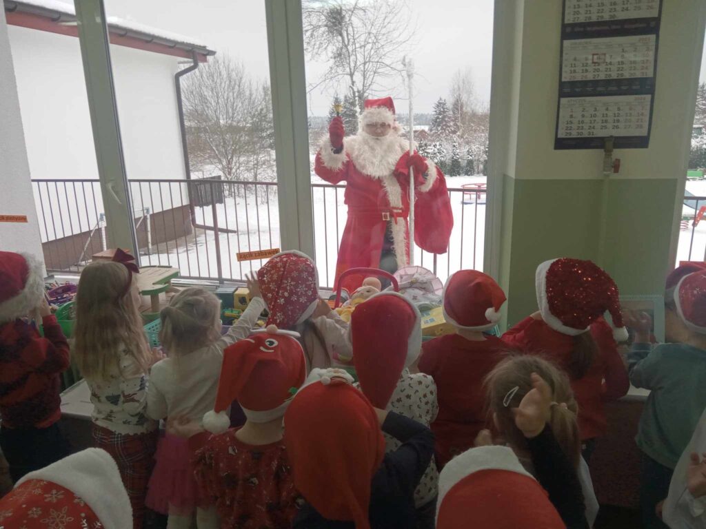 Zdjęcie przedstawia dzieci w sali przedszkolnej oraz mikołaja na podwórku.